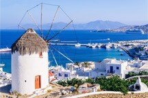 View of Mykonos and the famous windmill from above, Mykonos island, Greece View of Mykonos and the famous windmill from above, Mykonos island, Greece